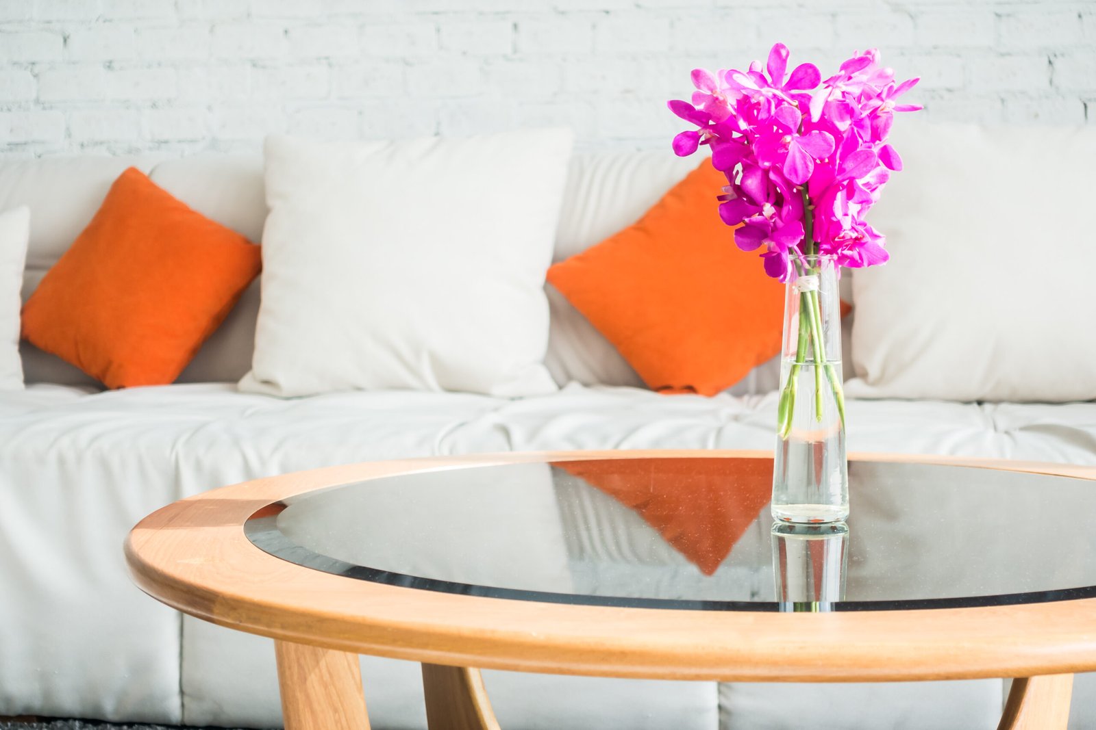 Vase flower with pillow on sofa decoration in living room interior